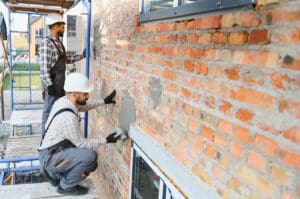 Signs Your Masonry Needs Repair Before It Becomes Structural 1 Pete’s Concrete & Masonry inspecting early masonry damage on a residential property